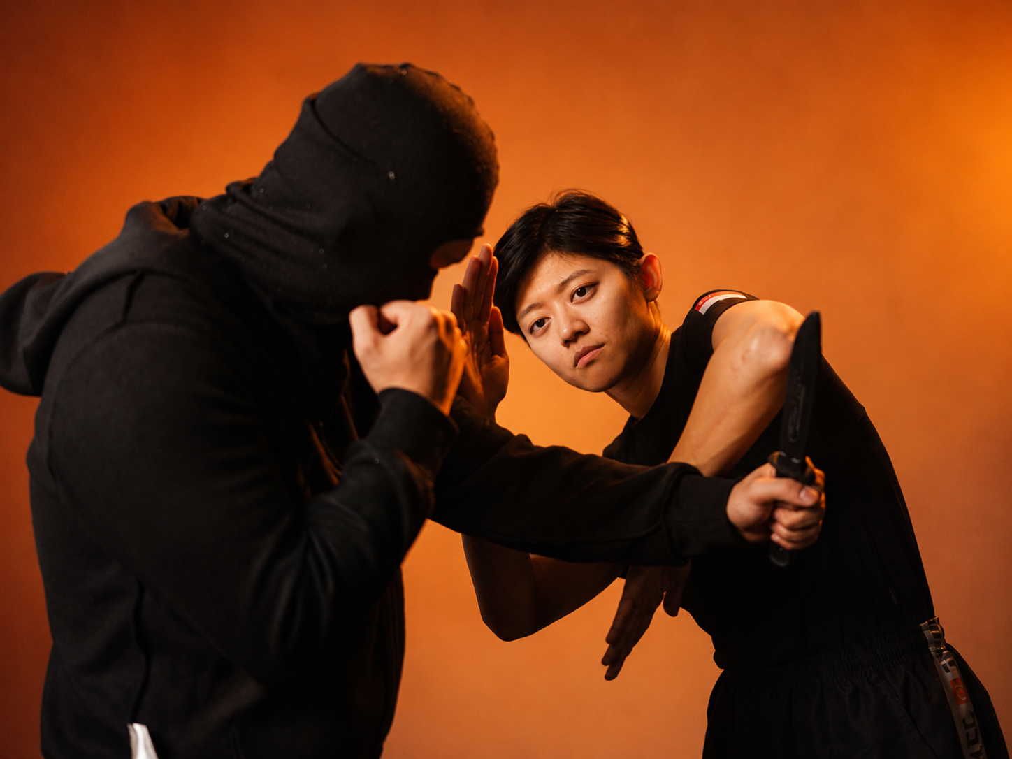 Minnie Teo training knife defence with a partner